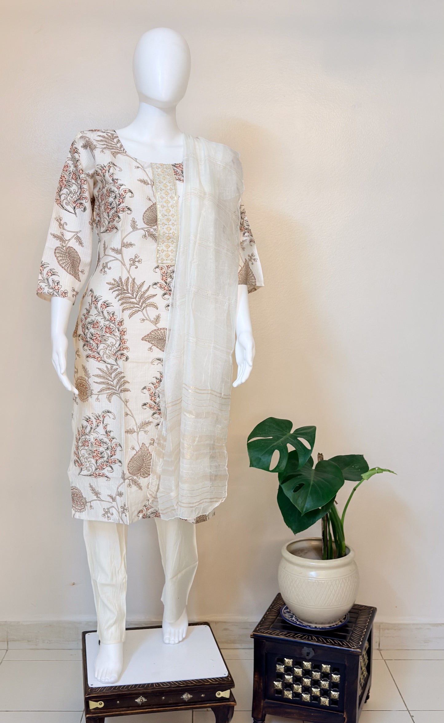 Mannequin wearing a white floral kurta set.