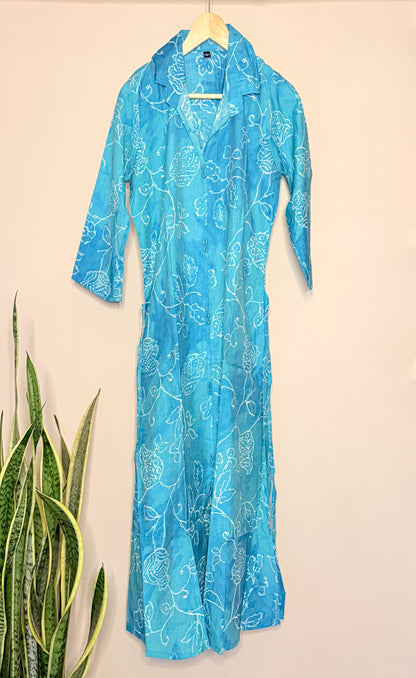 Blue floral-patterned coordset on a hanger against a beige background
