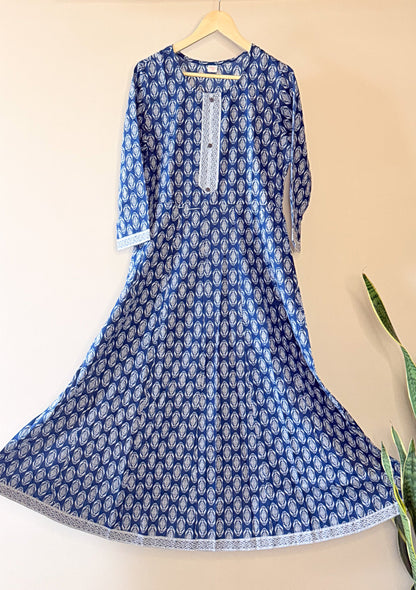 Blue anarkali patterned dress on a hanger against a beige background