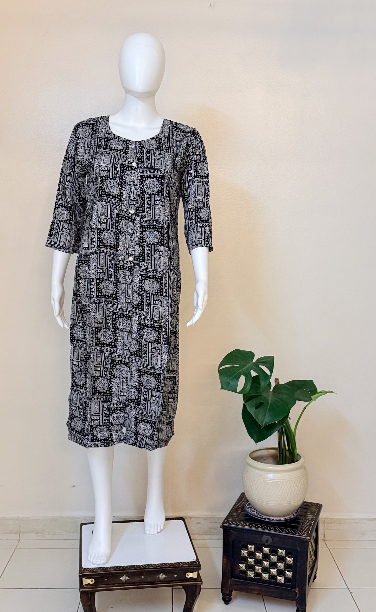 Mannequin wearing a black and white patterned dress.