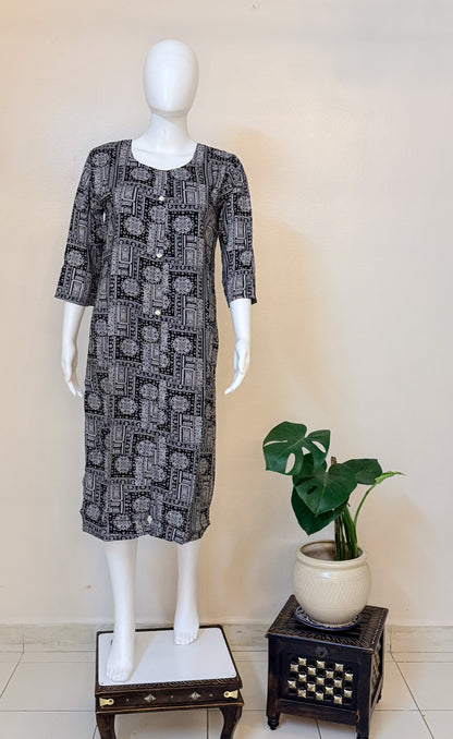 Mannequin wearing a black and white patterned dress.