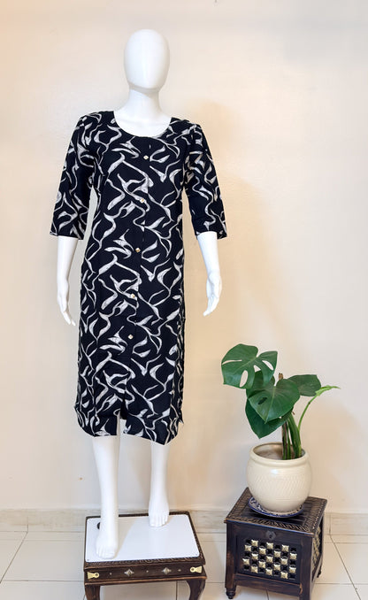 Mannequin wearing a black and white patterned dress.