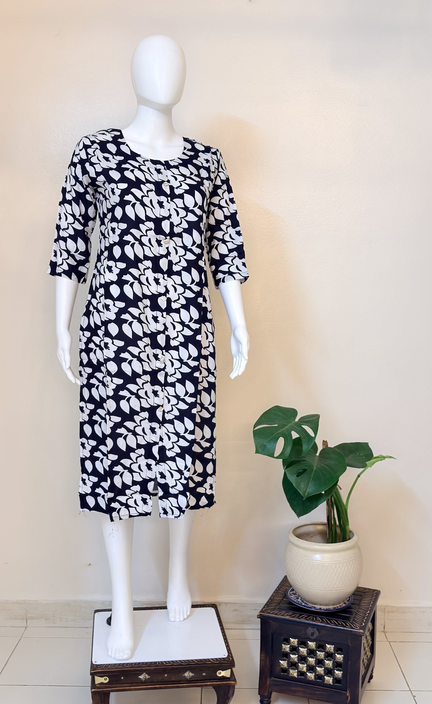 Mannequin wearing a black and white patterned dress.