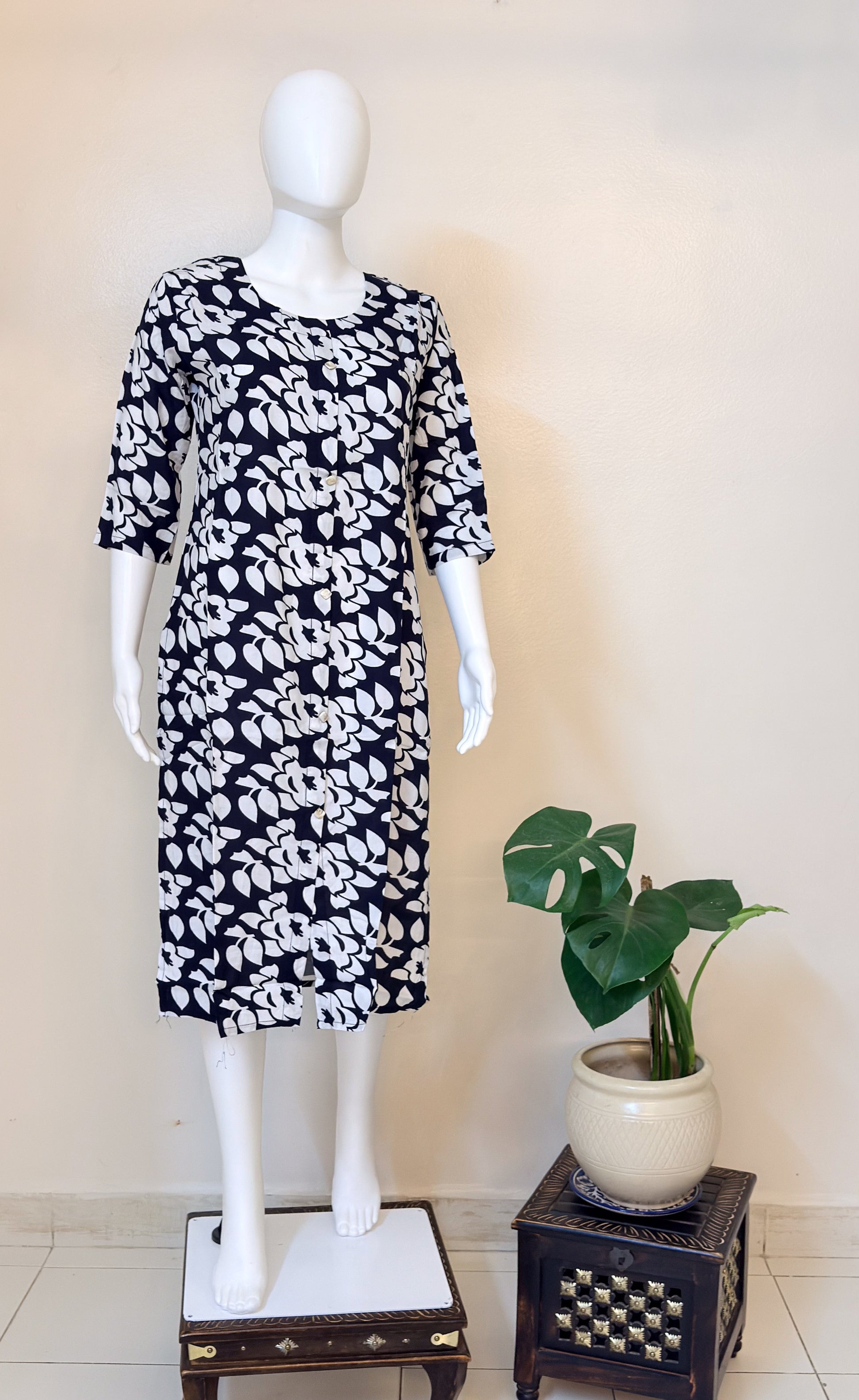 Mannequin wearing a black and white patterned dress.