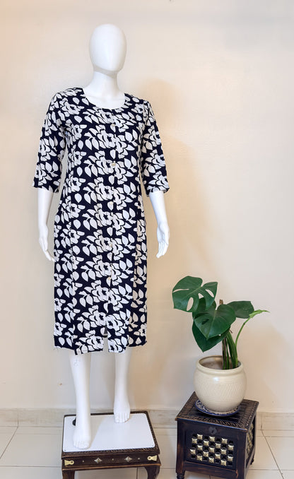 Mannequin wearing a black and white patterned dress.
