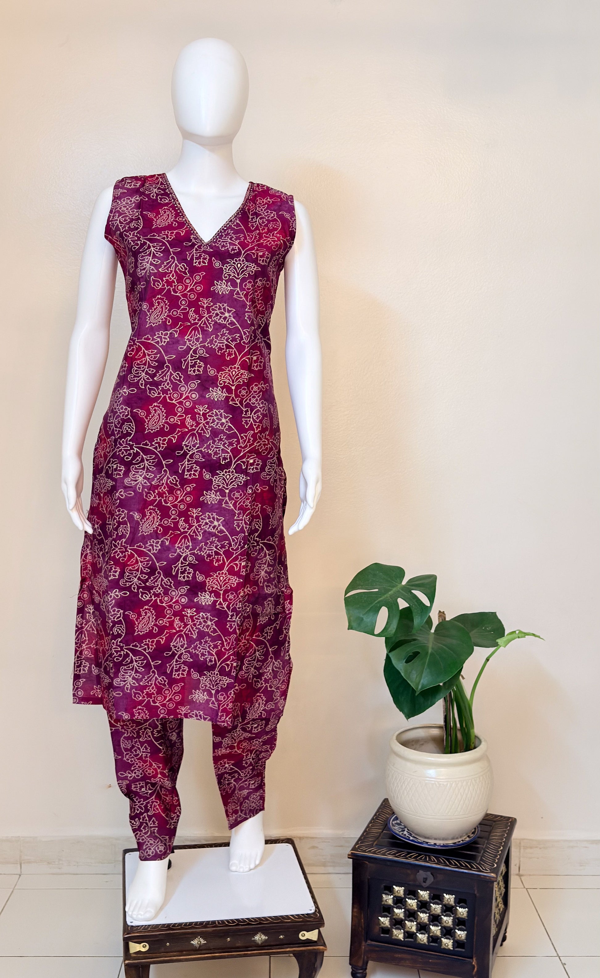 Mannequin wearing a purple floral coordset having v-neck.